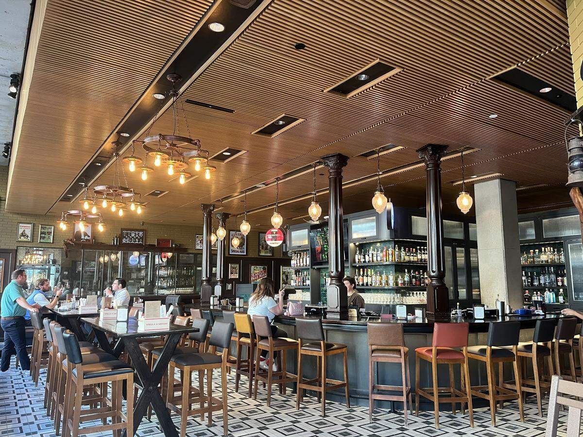 The inside of Henry McCarty’s mimics a traditional Irish pub with accents of dark wood, emerald green bar tiles and brass lanterns.