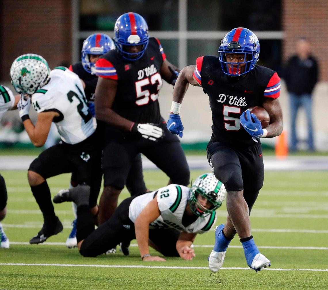 Duncanville running back Malachi Medlock (5) runs past Southlake linebacker Benecio Porras (32) for yards during a high school Class 6A Division 1 semifinal playoff game at McKinney ISD Stadium in McKinney, Texas, Saturday, Dec. 11, 2021. Duncanville led Southlake Carroll 21-3 at the half. (Special to the Star-Telegram Bob Booth)
