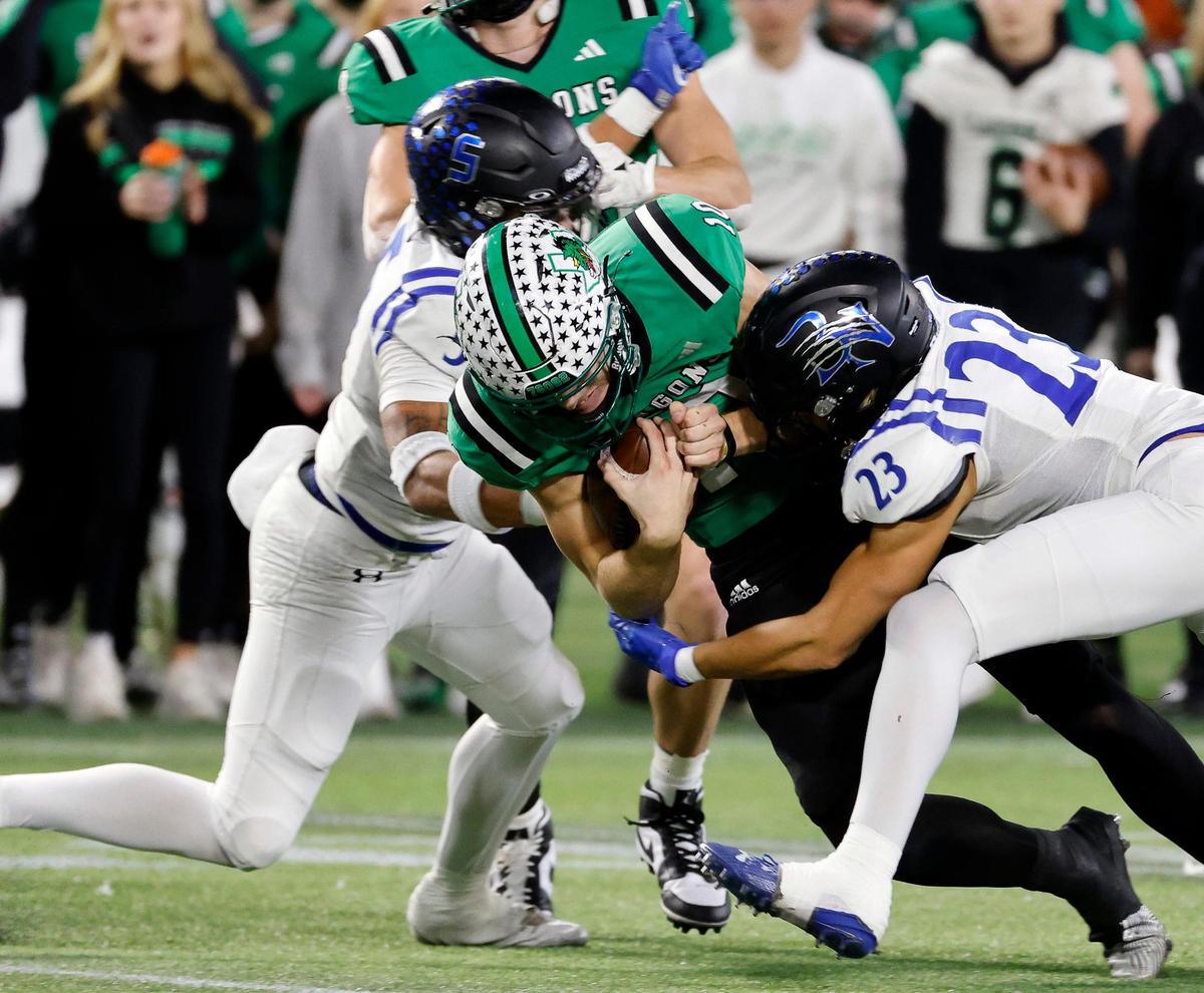Southlake Carroll quarterback Graham Knowles gets sandwiched by Byron Nelson defenders during the first half of a Class 6A Division II state quarterfinal Dec. 2, 2023, at Choctaw Stadium in Arlington.
