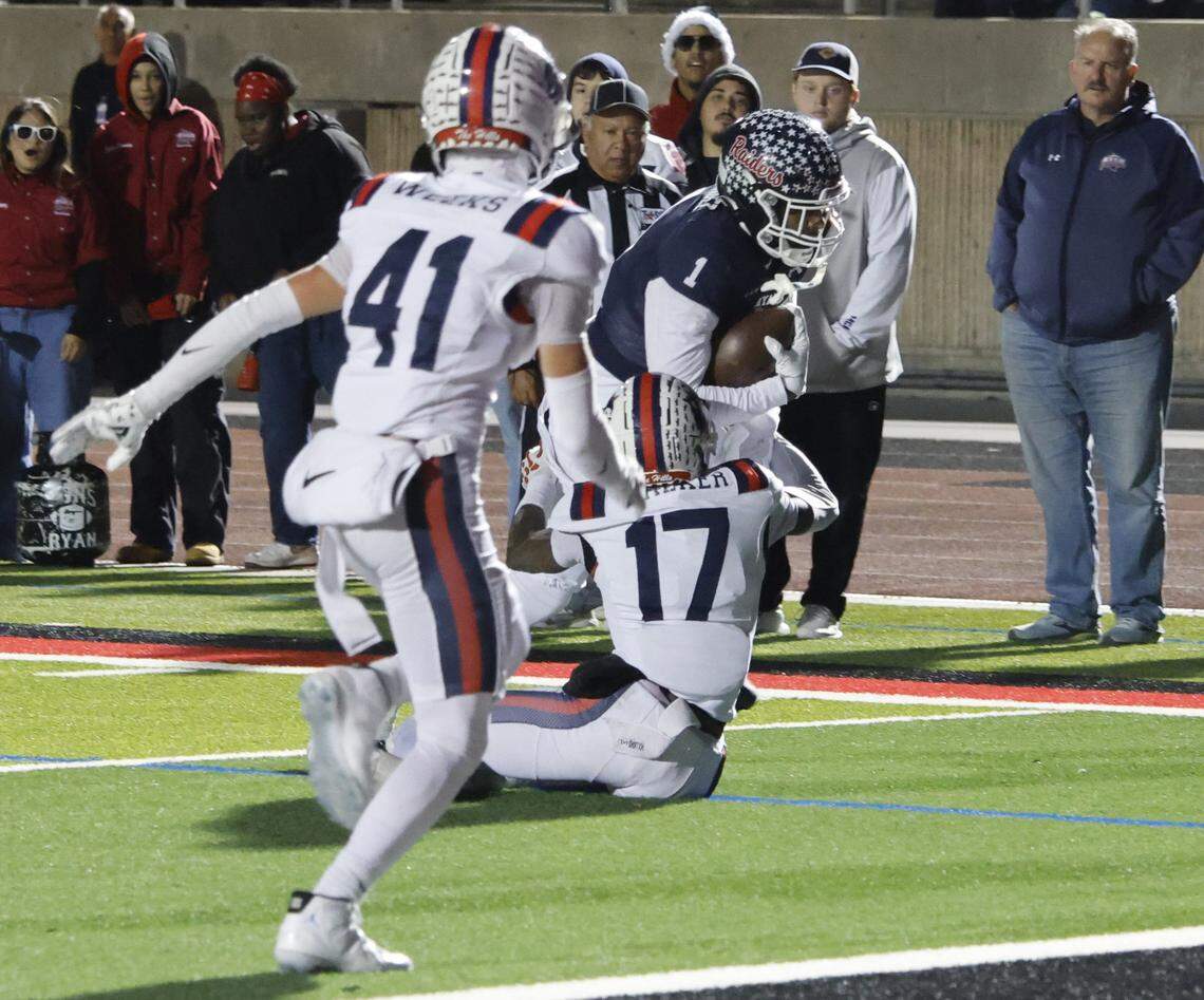 Denton Ryan halfback Jose Melendez (1) gets away from Richland defensive backs Jaxson Walker (17) Paxon Weeks (41) to score during the first half of a UIL Class 5A Division I Regional on Friday Nov. 28, 2025 at Buddy Echols Field in Coppell, Texas.