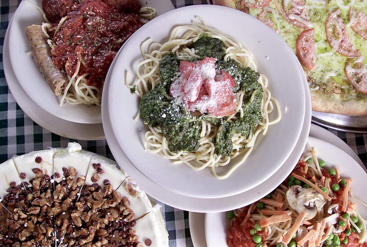 Spaghetti with meat sauce (clockwise fom top left), linguine primavera, pesto pastas and turtle cheesecake at Hysen’s Nizza Pizza.