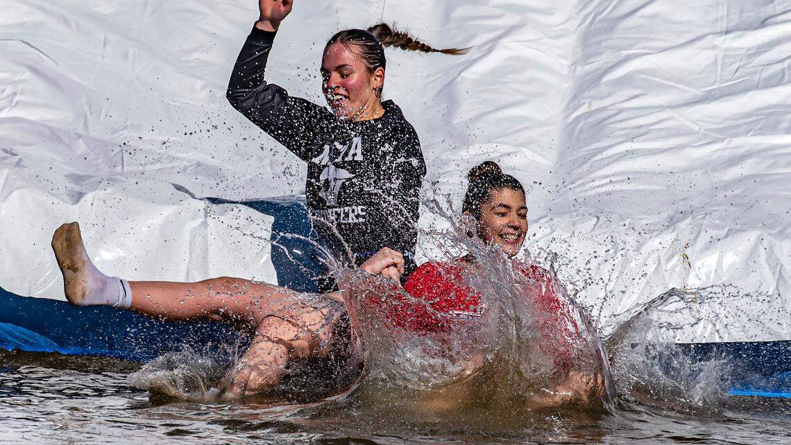 Annika Mijuskovic, 19, right, and Jana Cetkovic, 18, hold hands as they go down a 30-foot slide, splashing into Lake Granbury’s 51-degree water Saturday, Jan. 20, 2024, for the fourth edition of the Goosebump Jump in Granbury, Texas.. Mijuskovic marked her birthday by joining dozens of brave souls jumping into the cold lake. Both girls are seniors at the North Central Texas Academy and are from Serbia.