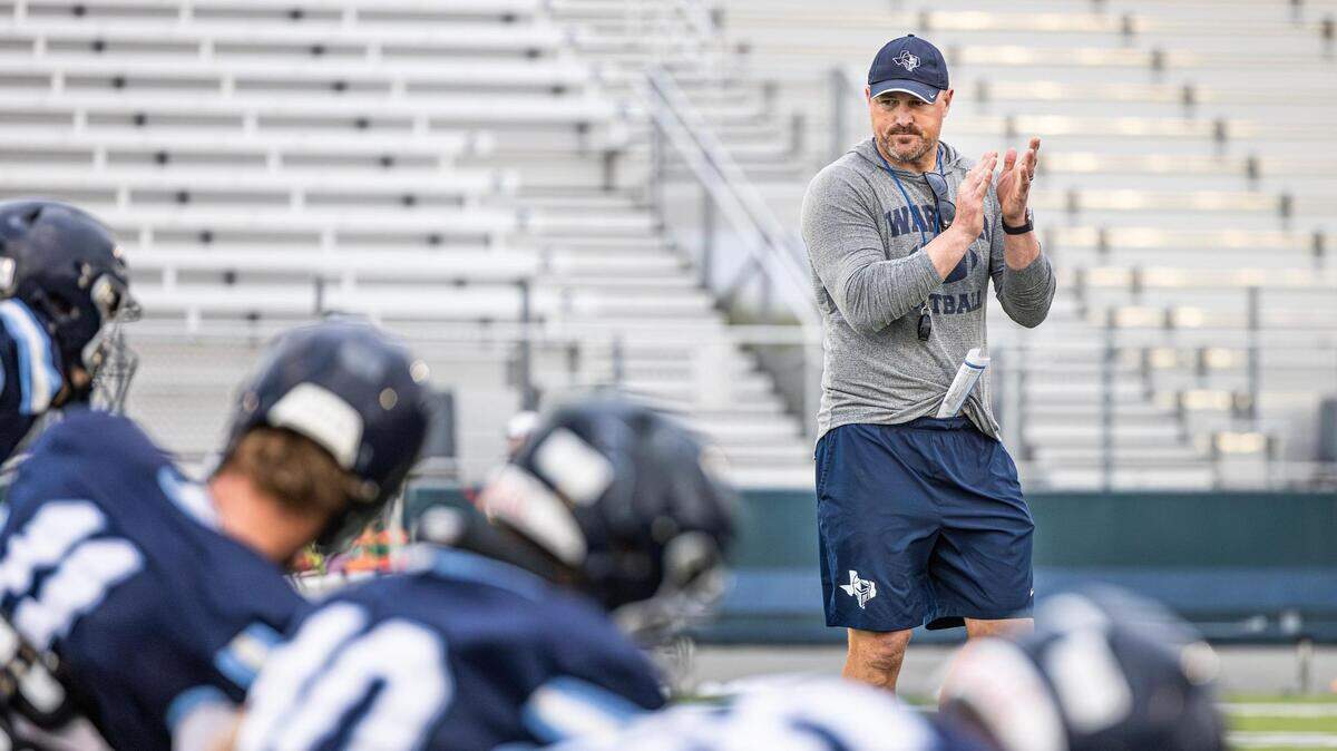 Liberty Christian Head Football Coach Jason Witten encourages his team in warm ups during football practice at Warrior Stadium at Liberty Christian School in Argyle, Texas on Tuesday, Aug. 15, 2023.