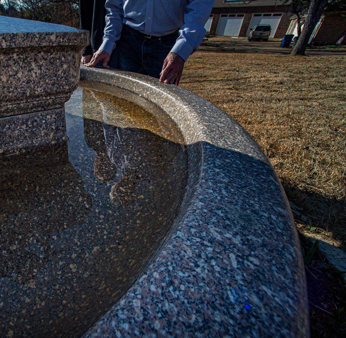 David Hunn replumbed the granite bowl that now sits on their front yard.