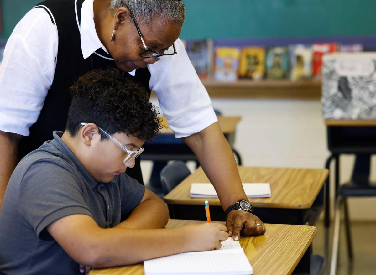 English teacher Jeannette Jones-Wilson helps sixth-grader Francisco Garcia during class on Tuesday, Sept. 10, 2024, at Wedgwood Middle School. Wedgwood Middle is among campuses in Fort Worth ISD that’s added a new cohort of sixth-graders this school year after officials closed all of the district’s stand-alone sixth-grade campuses.