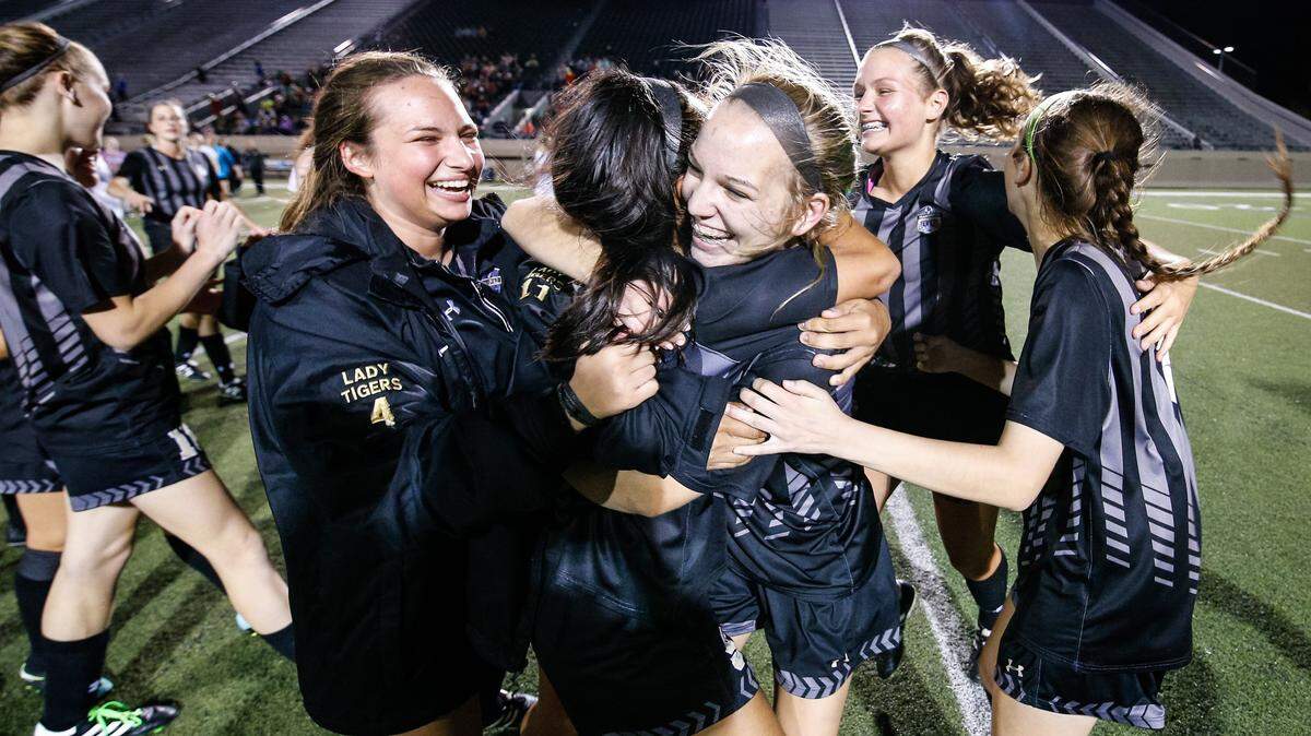 April 6, 2018; Dallas, TX, USA. The Mansfield Tigers celebrate on the field following a 2-0 victory over the Keller Central Chargers in a UIL girls regional quarterfinals soccer game at Pennington Field in Arlington, TX.