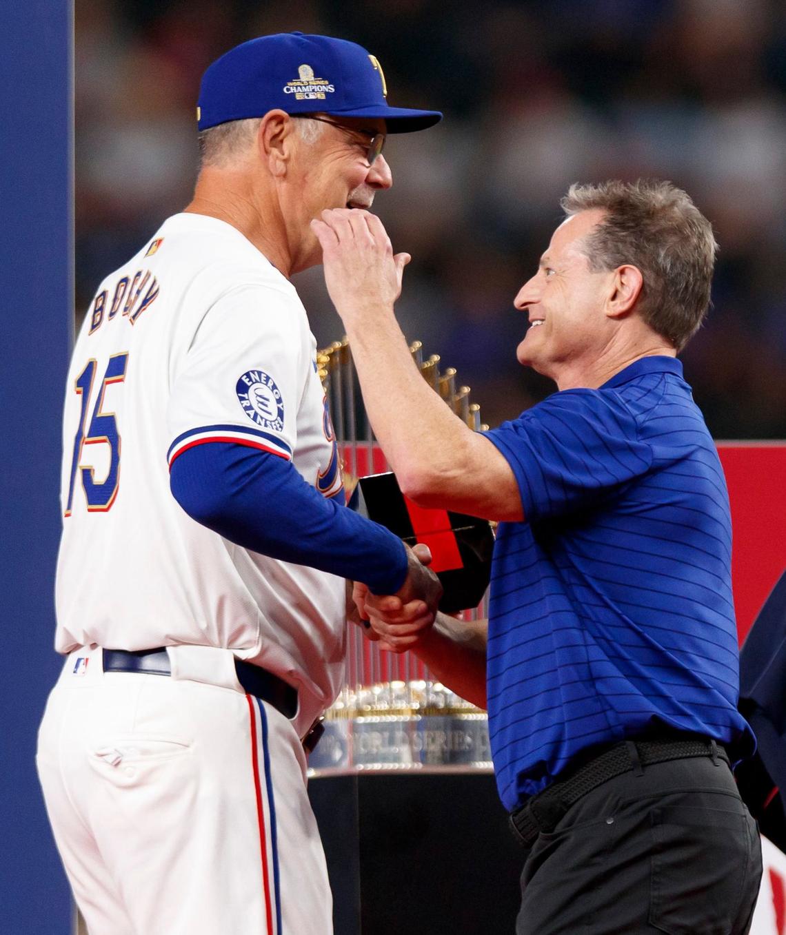 Texas Rangers manager Bruce Bochy shakes hands with team physician Dr. Keith Meister during the World Series ring ceremony on March 30, 2024, at Globe Life Field in Arlington.