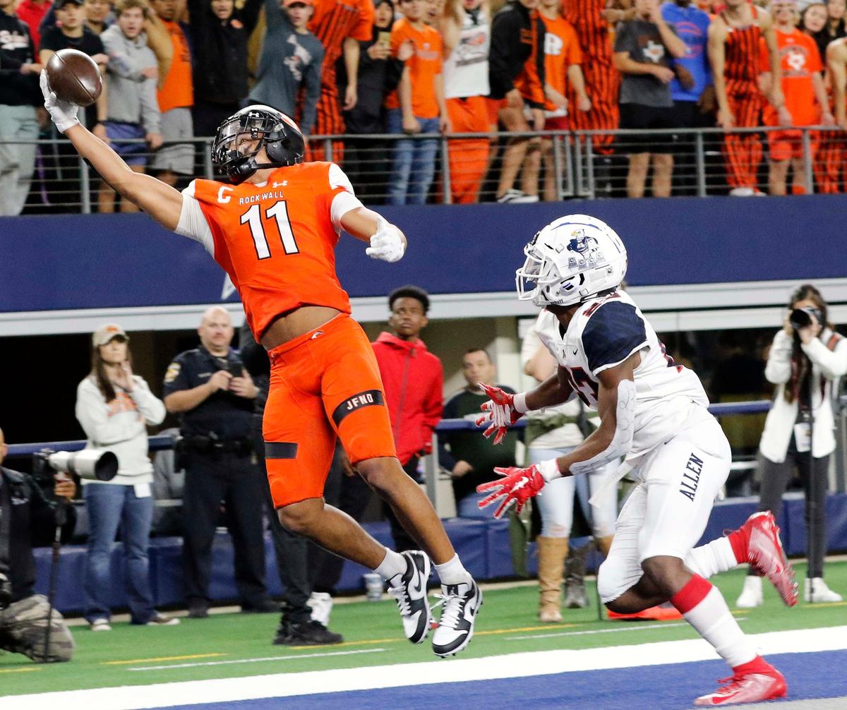 Rockwall receiver Jaxon Smith-Njigba one hands a touchdown pass in front of Allen defensive back Zayteak McGhee (23) in the first quarter of a high school football playoff game at AT&T Stadium in Arlington, Texas, Friday, Nov. 22, 2019. The Allen Eagles and Rockwall Yellowjackets were knotted at 38 at the half. (Special to the Star-Telegram Bob Booth)