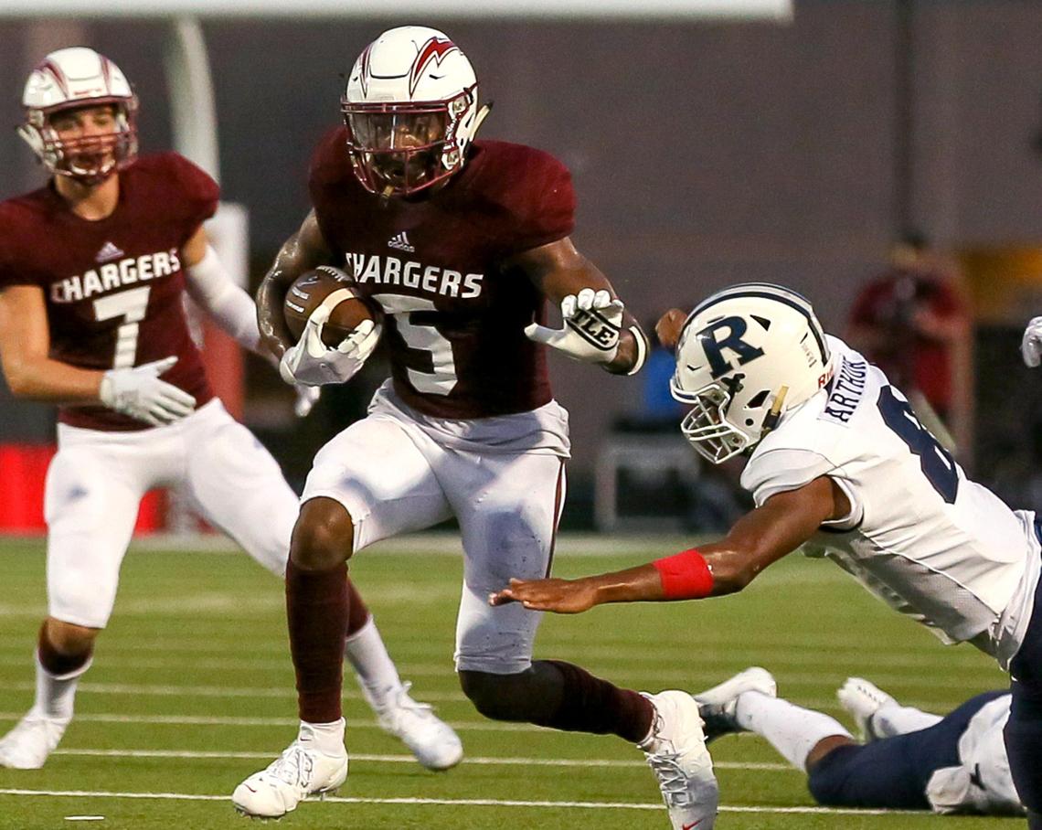 Keller Central wide receiver D.J. Graham (5) tries to avoid Richland defensive back Da’lon Arthur during the second half, Thursday night, September 5, 2019 played at Keller ISD Stadium in Keller, TX.