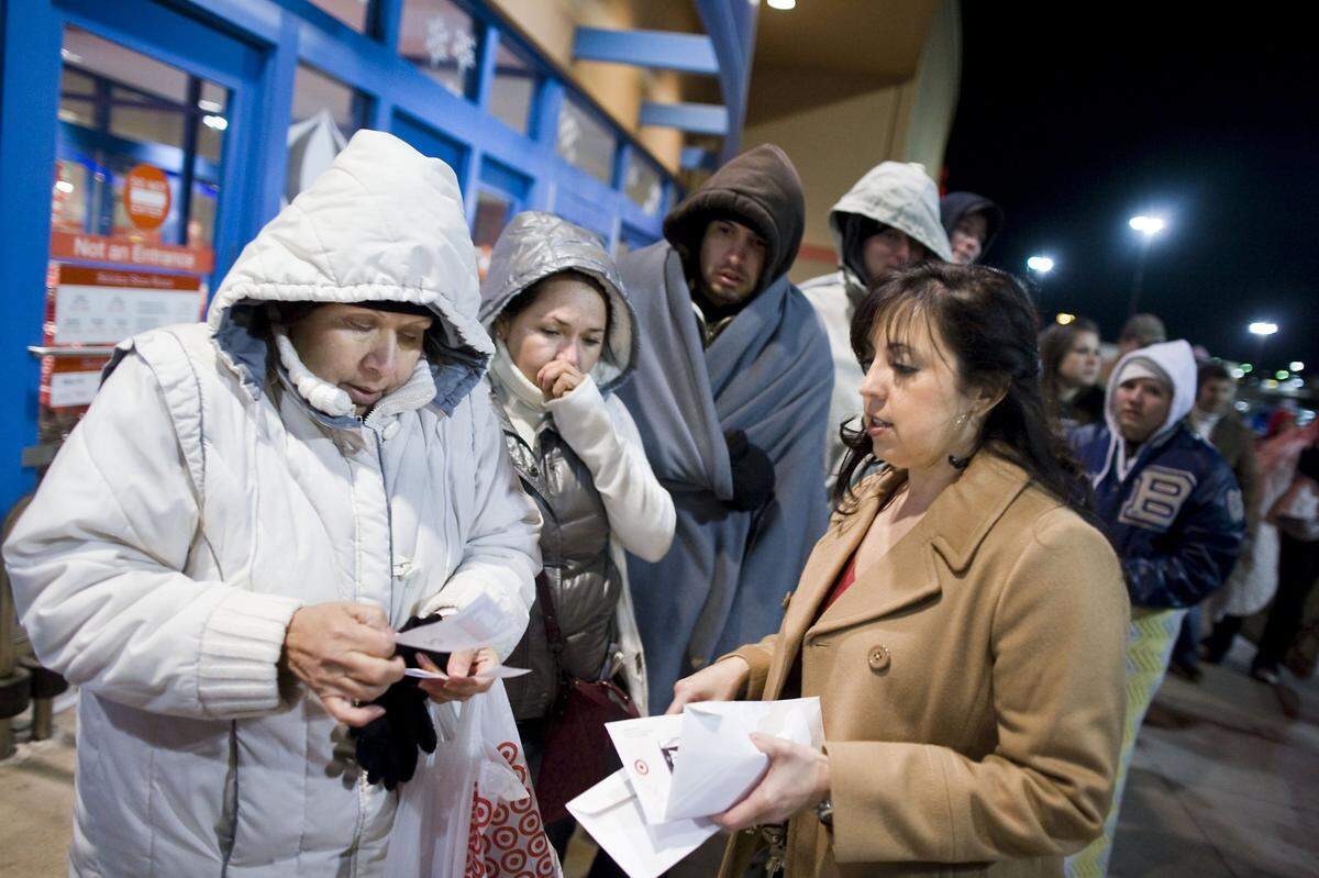 2010: Hilda Marrutto, Carolina Vasquez and Marco Reynaga receive tickets for big-item discounts from store manager Lisa Bushland at Target in Hurst, which opened at 4 a.m. on Black Friday. Hundreds of shoppers arrived hours earlier to get deals.