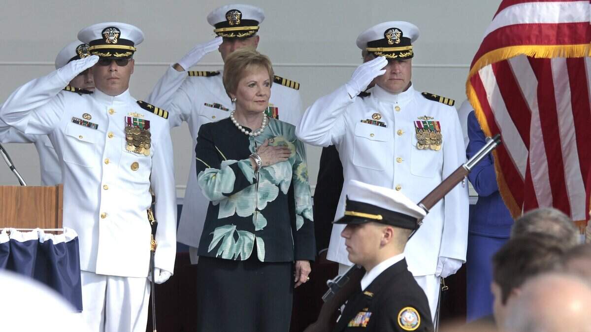 Rep. Kay Grangers stands at attention with Commanders Randy Blankenship, left, and Warren Cupps for the opening of the commissioning ceremony for the USS Fort Worth in Galveston on Sept. 22, 2012.
