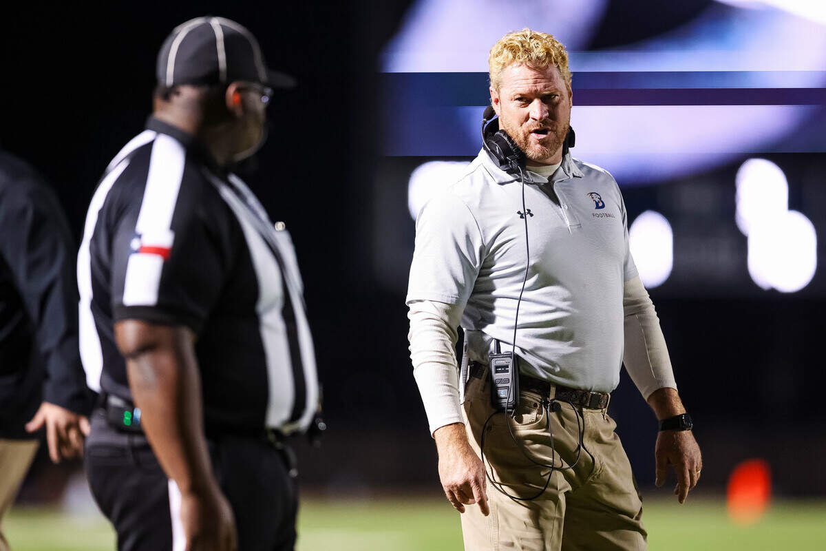 Brock head coach Billy Mathis talks to an official after a play in a Class 4A Division II state semifinal against Carthage on Friday at Memorial Stadium in Mesquite.