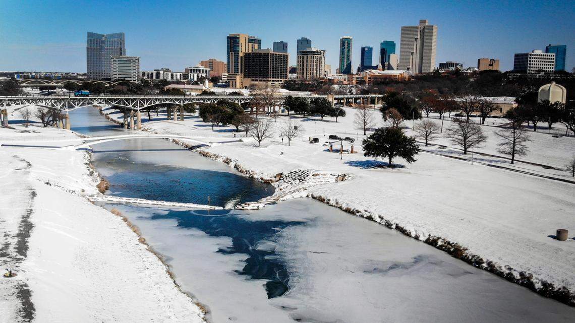 The Trinity River is mostly frozen after a snow storm Monday, Feb. 15, 2021, in Fort Worth. Weather forecasters are expecting freezing temperatures, ice and sleet this weekend. 