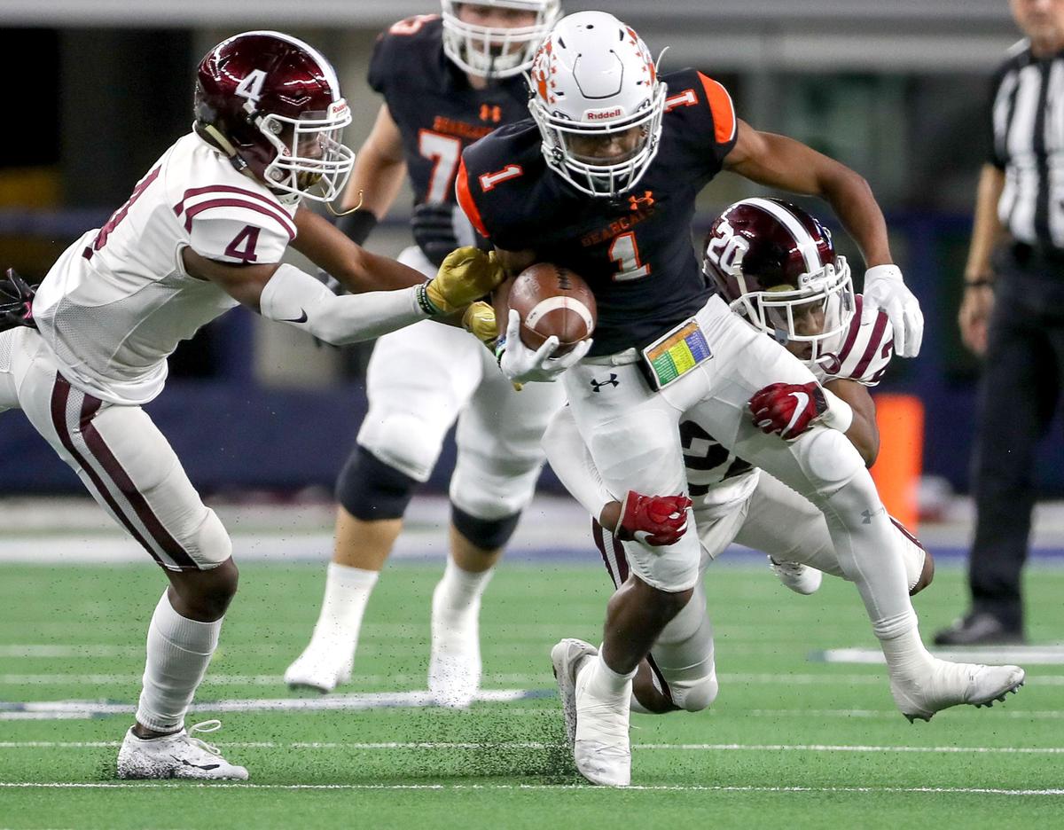 Aledo wide receiver Jo Jo Earle (1) tries to get the first down reception against Red Oak defensive back Elijah Shaw (20) and defensive back Darius Jackson (4) during the first half of their 5A Division II Regional Round High School Football playoff game at AT&T Stadium in Arlington, Tx Friday November 29, 2019.
