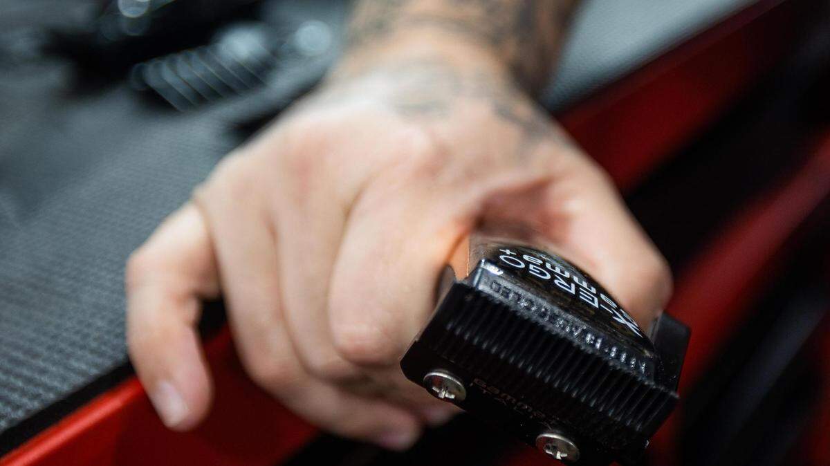 Owner Vinny Clark holds clippers as he cuts hair Friday, Aug. 12, 2022, at Texas Barber Cartel in Watauga.