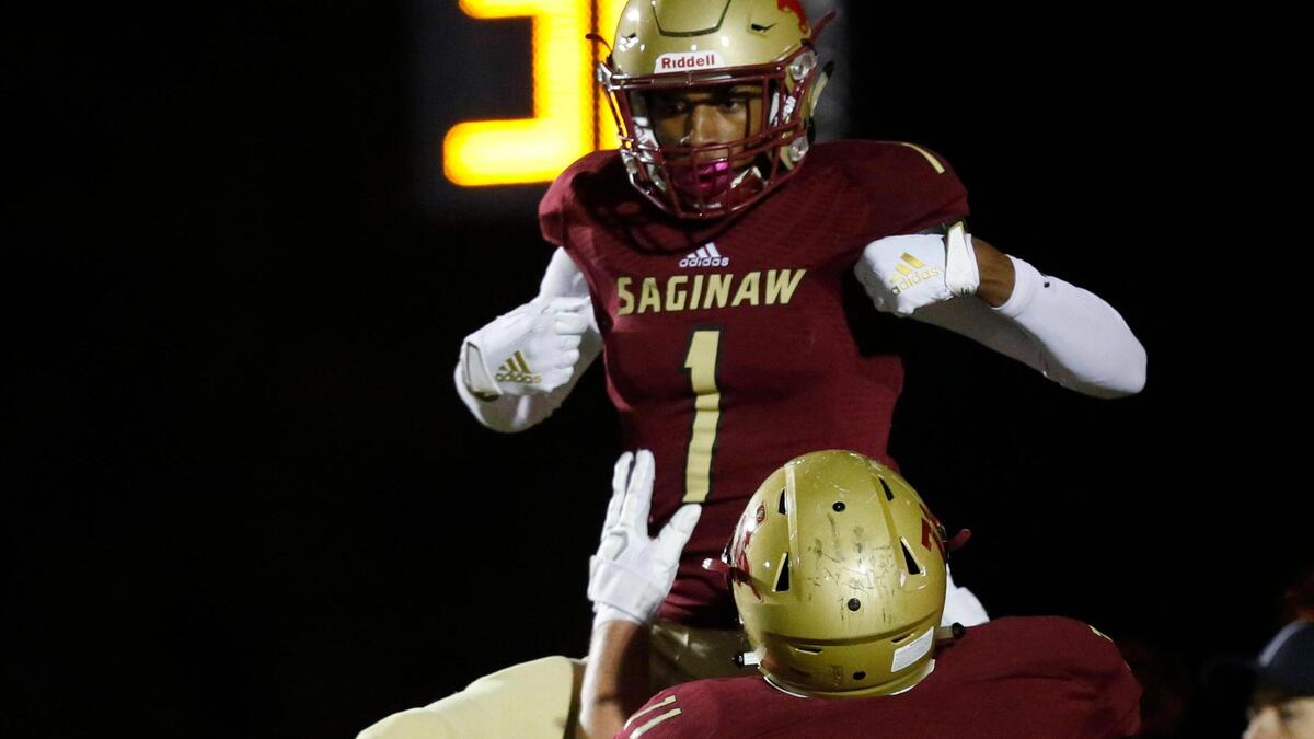 SaginawÕs Case Mason (71) hoists Blayne Taylor (1) in celebration after Taylor scored the Rough Riders’ third touchdown. The Granbury Pirates played the Saginaw Rough Riders in District 3-AAAAA, division 1 high school football Friday, November 8, 2019, at Rough Rider Stadium in Saginaw, Texas.