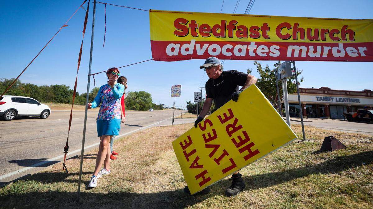 Protesters put up signs along Denton Highway outside Stedfast Baptist Church on July 24. Leaders of other churches across North Texas have condemned the messages of hate and violence coming from the pulpit at Stedfast. Some have supported the people who demonstrate, saying the sermons twist the word of God and don’t represent Christianity.