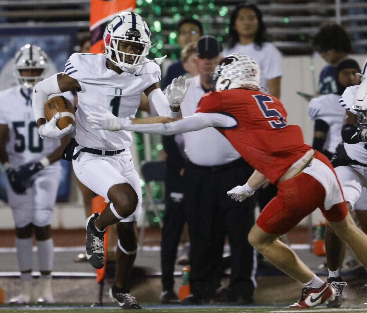 Oakridge wide receiver Kingston Parks (1) runs past the attempted tackle by Country Day defender Owen Bloemendal during the first half of the SPC 2025 3A Football Championship football game between The Oakridge School and Fort Worth Country Day at Mavericks Stadium in Arlington, Texas, Saturday Nov. 08, 2025.