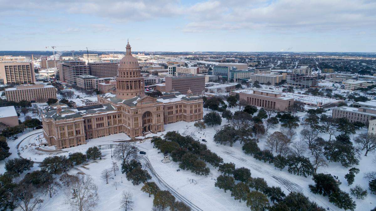 The Capitol grounds are covered in snow in Austin, Texas on Monday Feb. 15, 2021. (Jay Janner/Austin American-Statesman via AP)
