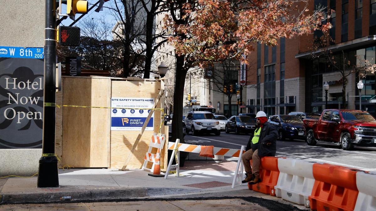 A security guard sits at Houston Street and Eighth Street on Jan. 13, 2024, after Houston Street was opened following cleanup from the explosion in the Sandman Signature Hotel in Fort Worth, Texas. Twenty-one people were injured in the explosion.