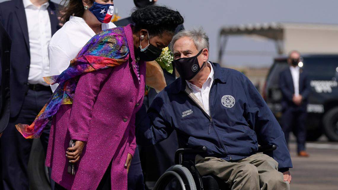 Rep. Sheila Jackson Lee, D-Texas, speaks with Texas Gov. Greg Abbott, greeting President Joe Biden and first lady Jill Biden at Ellington Field Joint Reserve Base in Houston on Friday. Abbott on Tuesday announced he’s lifting Texas’ mask mandate and opening businesses 100% starting March 10.