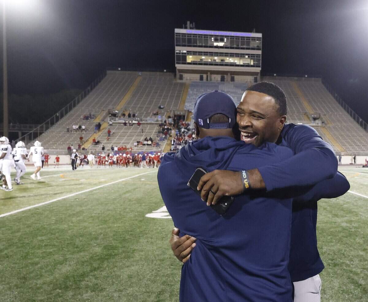 Oakridge head coach Jeromy Flowers hugs another coach in the remaining few seconds of the second half of the SPC 2025 3A Football Championship football game between The Oakridge School and Fort Worth Country Day at Mavericks Stadium in Arlington, Texas, Saturday Nov. 08, 2025.