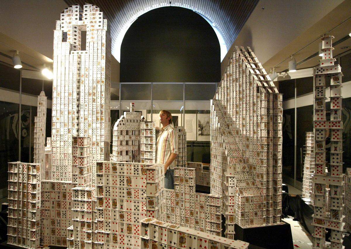 Oct. 22, 2006: Cardstacker Bryan Berg stands in the middle of the Dallas skyline he constructed out of playing cards at the State Fair of Texas. Berg used a leaf blower to knock the cards down after the exhibit ended.