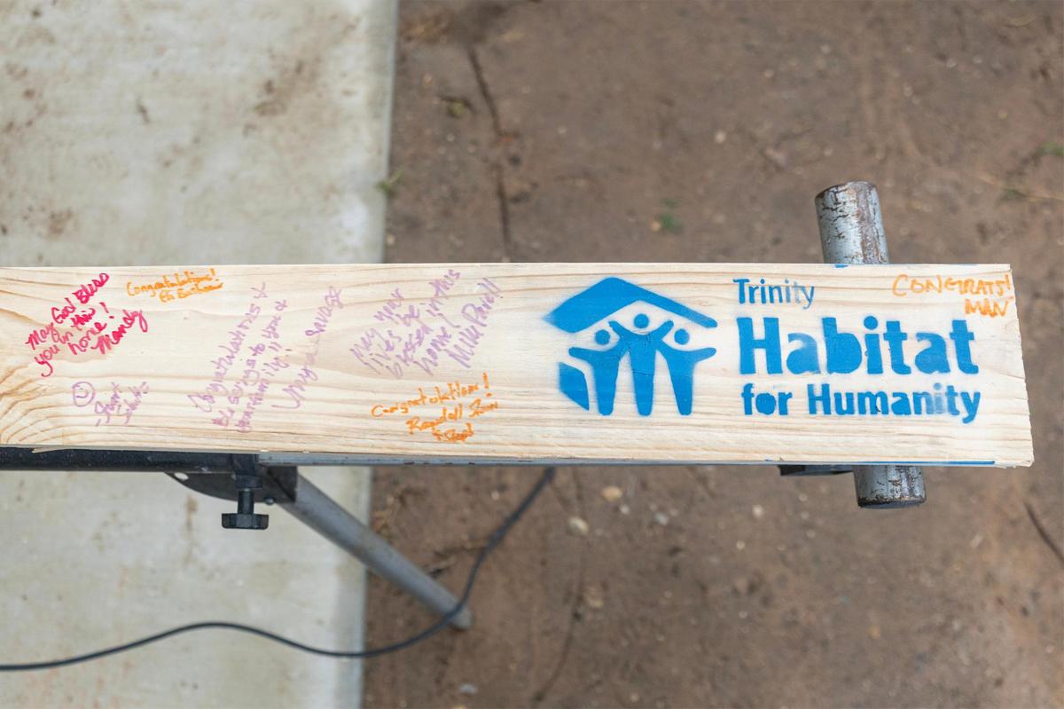 Volunteers signed a piece of wood for the first home built as part of the Opal Lee 100 Legacy Home initiative at the Historic Rosedale neighborhood in Fort Worth on Friday, April 25.