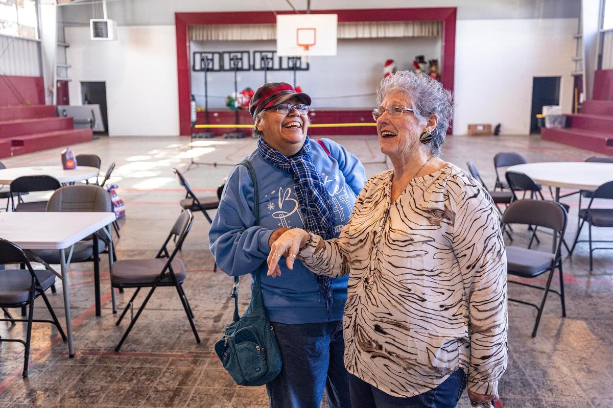 Laura Linan, left, and D.K. Winef share a laugh following a monthly community luncheon for the Justin-area seniors at City Hall on Jan. 15.