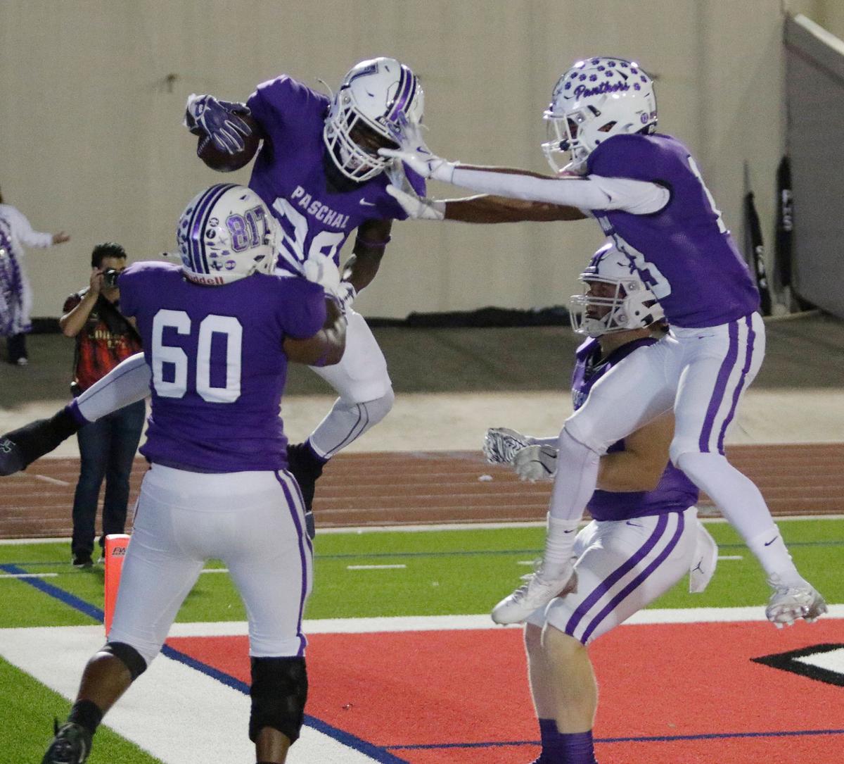 Pashal’s players celebrate with Marquez Dean after Dean scores a touchdown during a UIL football game at Farrington Field Stadium on Thursday, October 4, 2024.