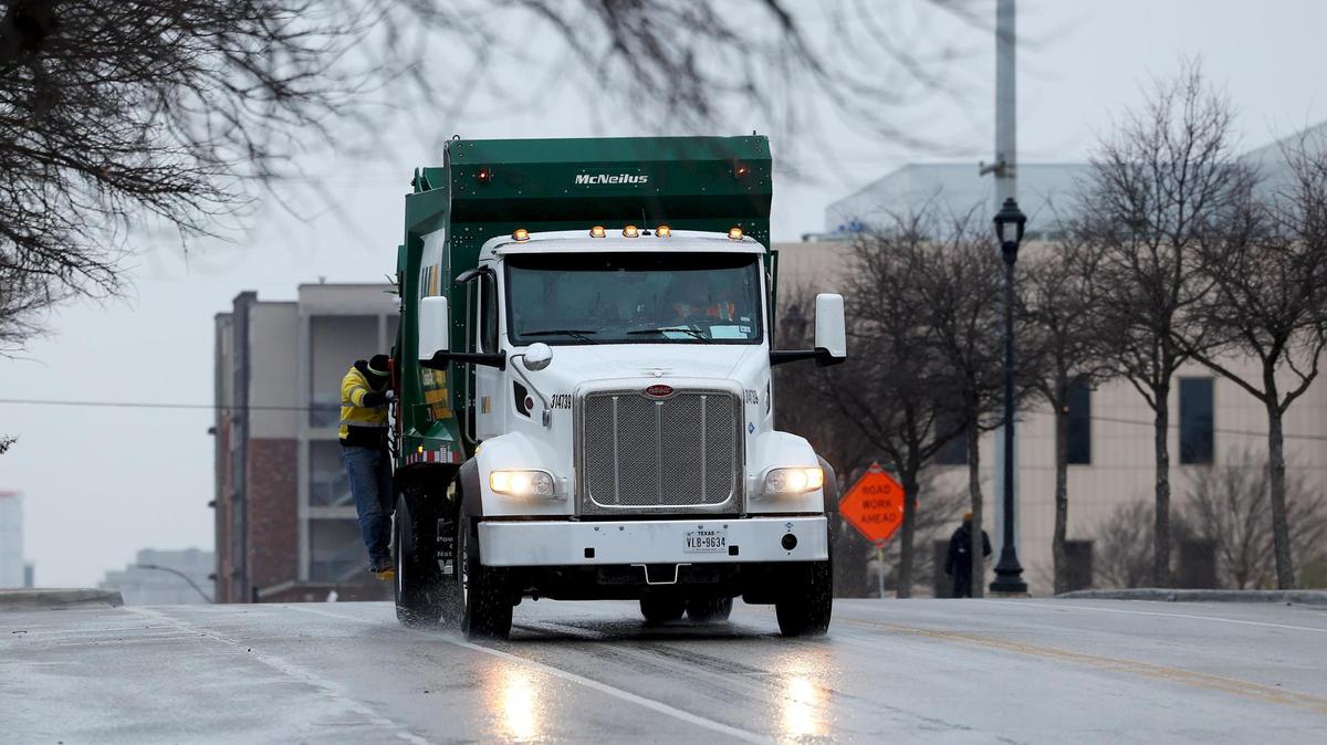 A Waste Management truck drives on South Main Street in the Near Southside neighborhood of Fort Worth on Thursday, Jan. 9, 2025. A winter storm warning is in effect for North Texas.
