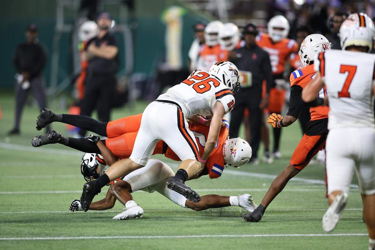 Haltom linebacker Logan Lange (26) forces an Arlington Bowie fumble on Thursday, Oct. 23, 2025, at Choctaw Stadium in Arlington.