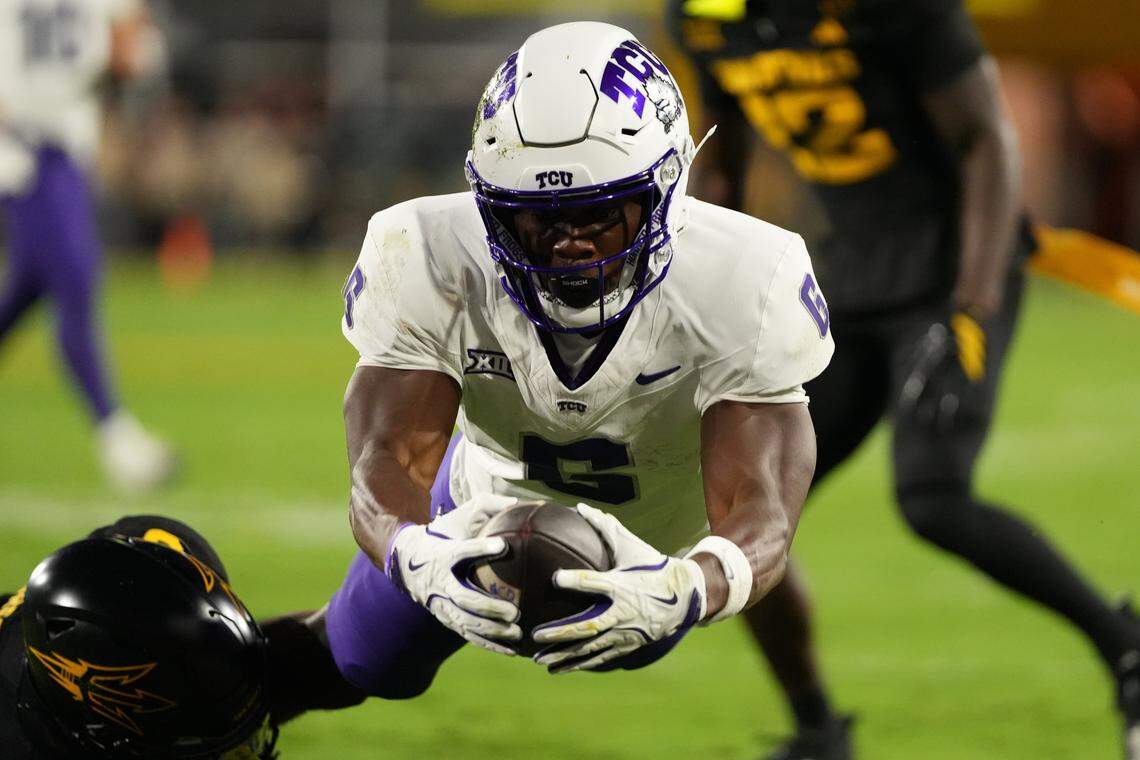 Sep 26, 2025; Tempe, Arizona, USA; TCU Horned Frogs running back Trent Battle (6) leaps to score a touchdown against the Arizona State Sun Devils in the first half at Mountain America Stadium, Home of the ASU Sun Devils. Mandatory Credit: Jacob Reiner-Imagn Images
