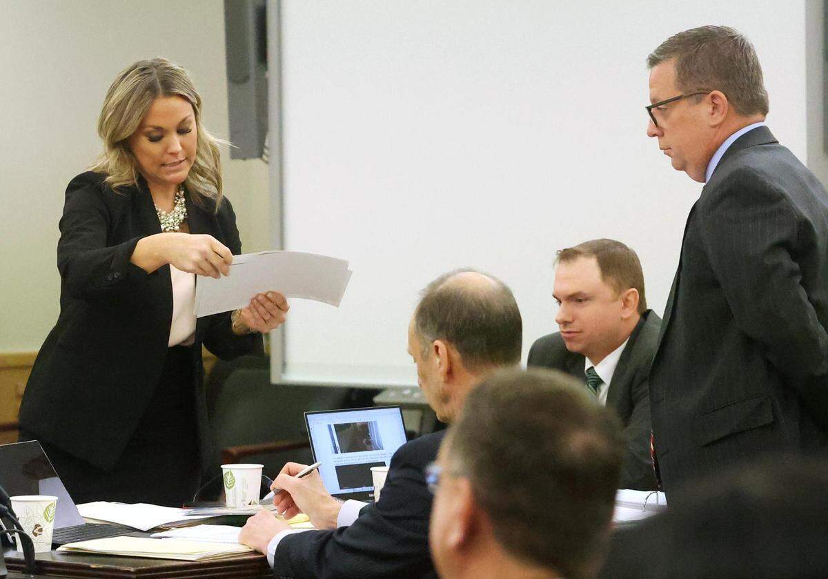 Assistant Criminal District Attorney Ashlea Deener shows the defense team photographs submitted as evidence during the second day of the murder trial of Aaron Dean on Tuesday, December 6, 2022, in Fort Worth.