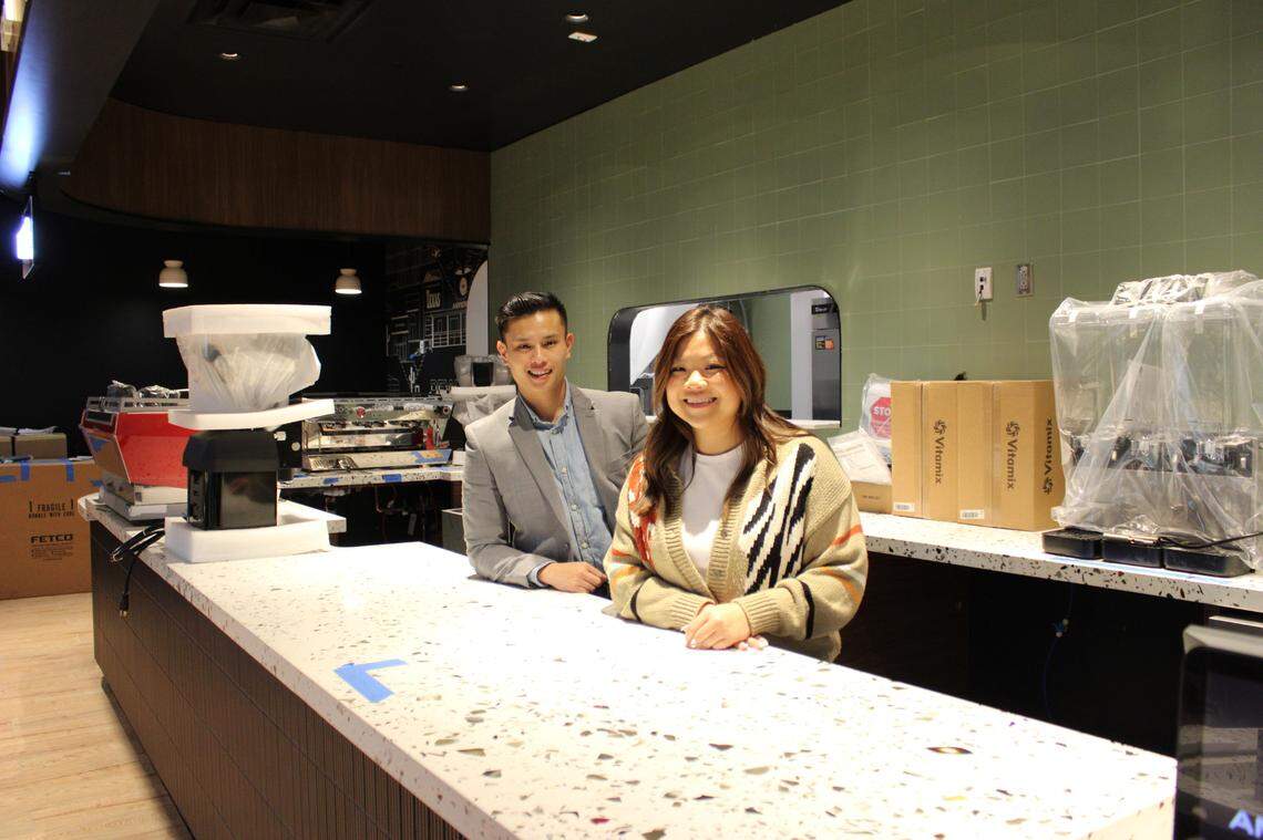Toan Luong, left, and Mimi Lu, right, behind the coffee bar at their airport coffee shop. A pinch-me moment for both Fort Worth entrepreneurs.