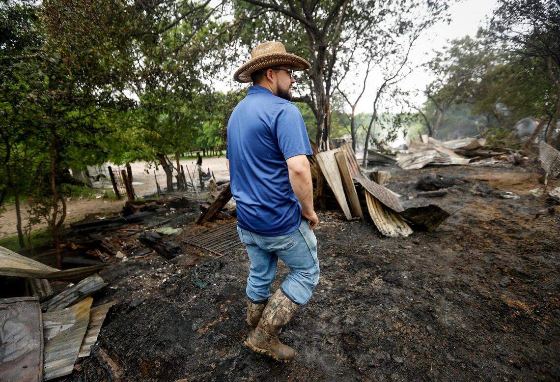 Adrian Castillo looks over what remains of his family’s horse stable on Wednesday, April 24, 2019, in Fort Worth. Several train cars derailed early Wednesday and caught fire. The fire spread to a nearby horse stable on Atkins Street, causing complete devastation and killing three horses.