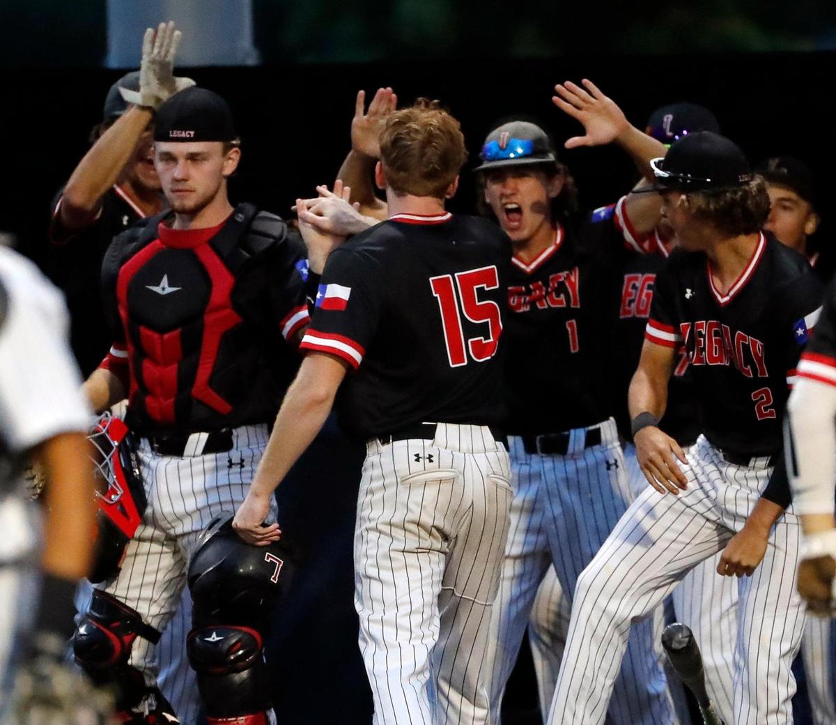 Legacy pitcher Adam Stelmar (15) is welcomed to the dugout after scoring in game one of a 5A Region I final baseball game at Cleburne High School, Texas, Friday, June 03, 2022. Legacy defeated Aledo 8-5 in the first game of a best of three series. (Special to the Star-Telegram Bob Booth)