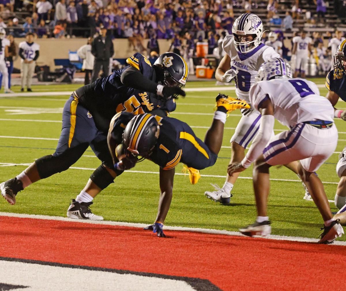 Arlington Heights running back Carson James (1) leaps into the end zone for six during the Battle of the Bonfire UIL District 4-5A D1 football game at Farrington Field in Fort Worth, Texas, Friday, Nov. 08, 2024.