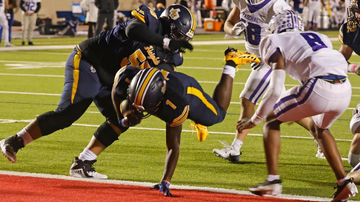 Arlington Heights running back Carson James (1) leaps into the end zone for six during the Battle of the Bonfire UIL District 4-5A D1 football game at Farrington Field in Fort Worth, Texas, Friday, Nov. 08, 2024.