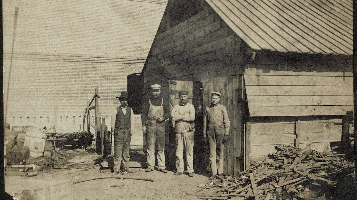 Blacksmiths who worked on the construction of the Swift & Co. meatpacking plant in 1902-1903. H. R. “Gus” Eilenberger is second from the right, and Sam H. Smith is on the right.