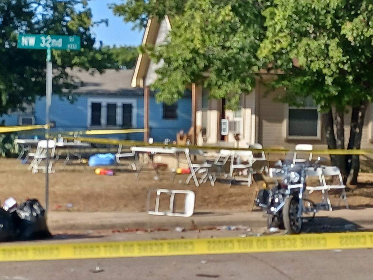 Crime tape marks the scene at Ross Avenue and NW 32nd Street, where police said that officers shot and killed two men.