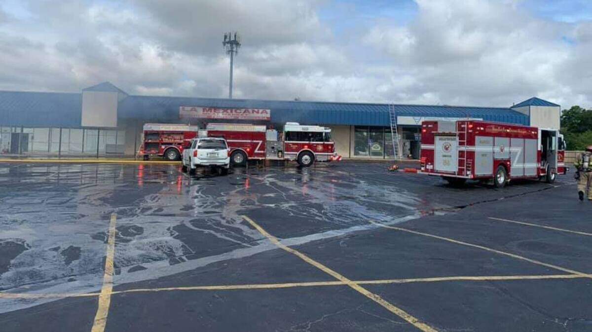 Haltom City firefighters respond to a blaze at La Mexicana Meat Market located in the 4100 block of Denton Highway on Tuesday morning. The fire spread throughout the business and a section of the roof collapsed.