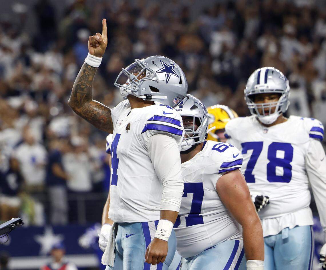 Dallas Cowboys quarterback Dak Prescott celebrates after scoring a touchdown in the second quarter against the Green Bay Packers on Sunday at AT&T Stadium in Arlington.