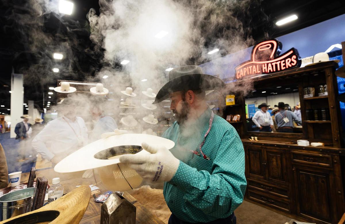 Cody Collins of Capital Hatters shapes a hat for a customer at the Cattle Raisers Expo and Convention’s exhibit hall on Friday, April 11, 2025, in Fort Worth.