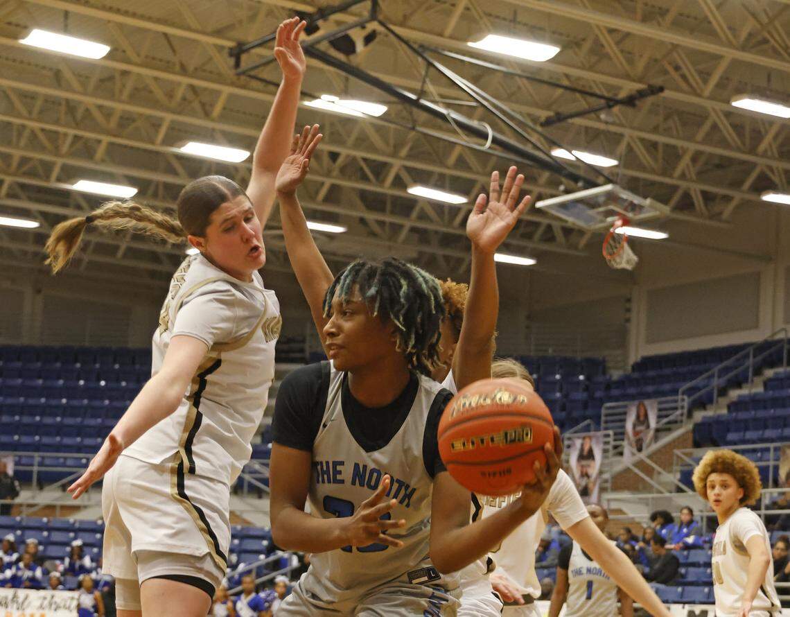 North Crowley forward Mecca Crawford (23) gets the ball out of trouble defended by Mansfield shooting forward Kylie Farnan (24) during the first half of a UIL girls basketball game between North Crowley and Mansfield at Mansfield High School in Mansfield, Texas, Tuesday Jan. 20, 2026