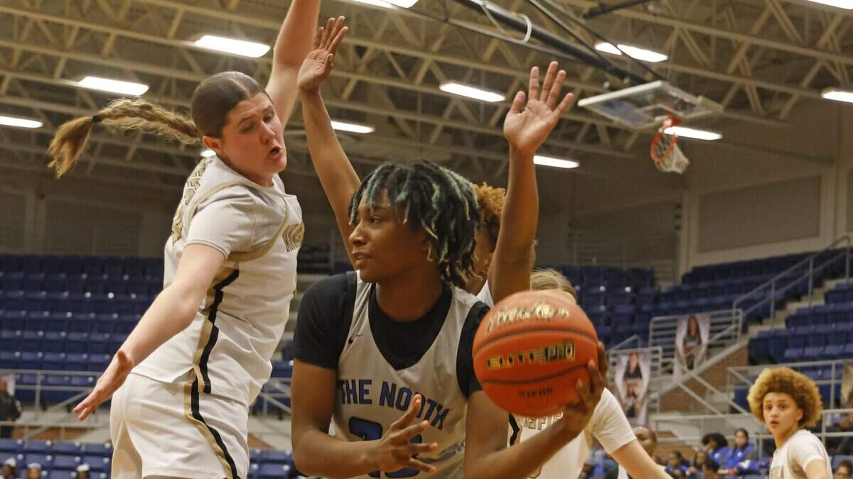 North Crowley forward Mecca Crawford (23) gets the ball out of trouble defended by Mansfield shooting forward Kylie Farnan (24) during the first half of a UIL girls basketball game between North Crowley and Mansfield at Mansfield High School in Mansfield, Texas, Tuesday Jan. 20, 2026