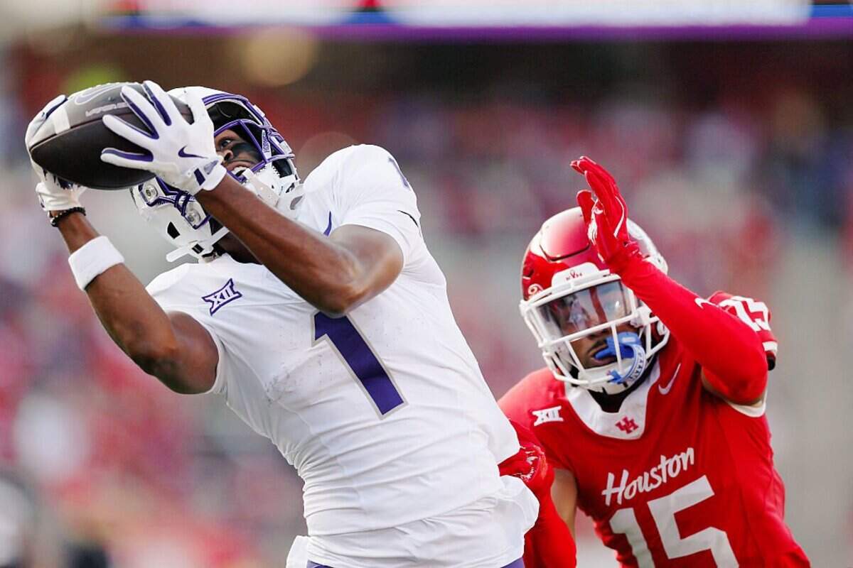 HOUSTON, TEXAS - NOVEMBER 22: Eric McAlister #1 of the Texas Christian University Horned Frogs makes a catch for a touchdown against Will James #15 of the Houston Cougars in the first quarter of the game at TDECU Stadium on November 22, 2025 in Houston, Texas. (Photo by Kenneth Richmond/Getty Images)