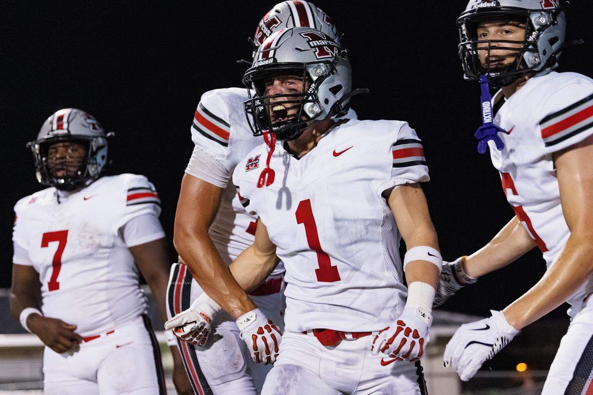 Flower Mound Marcus wide receiver Austin Allen screams in celebration with his teammates after catching a touchdown in the first quarter of a non-district game between Keller and Flower Mound Marcus at Keller ISD Stadium on August 28, 2025.