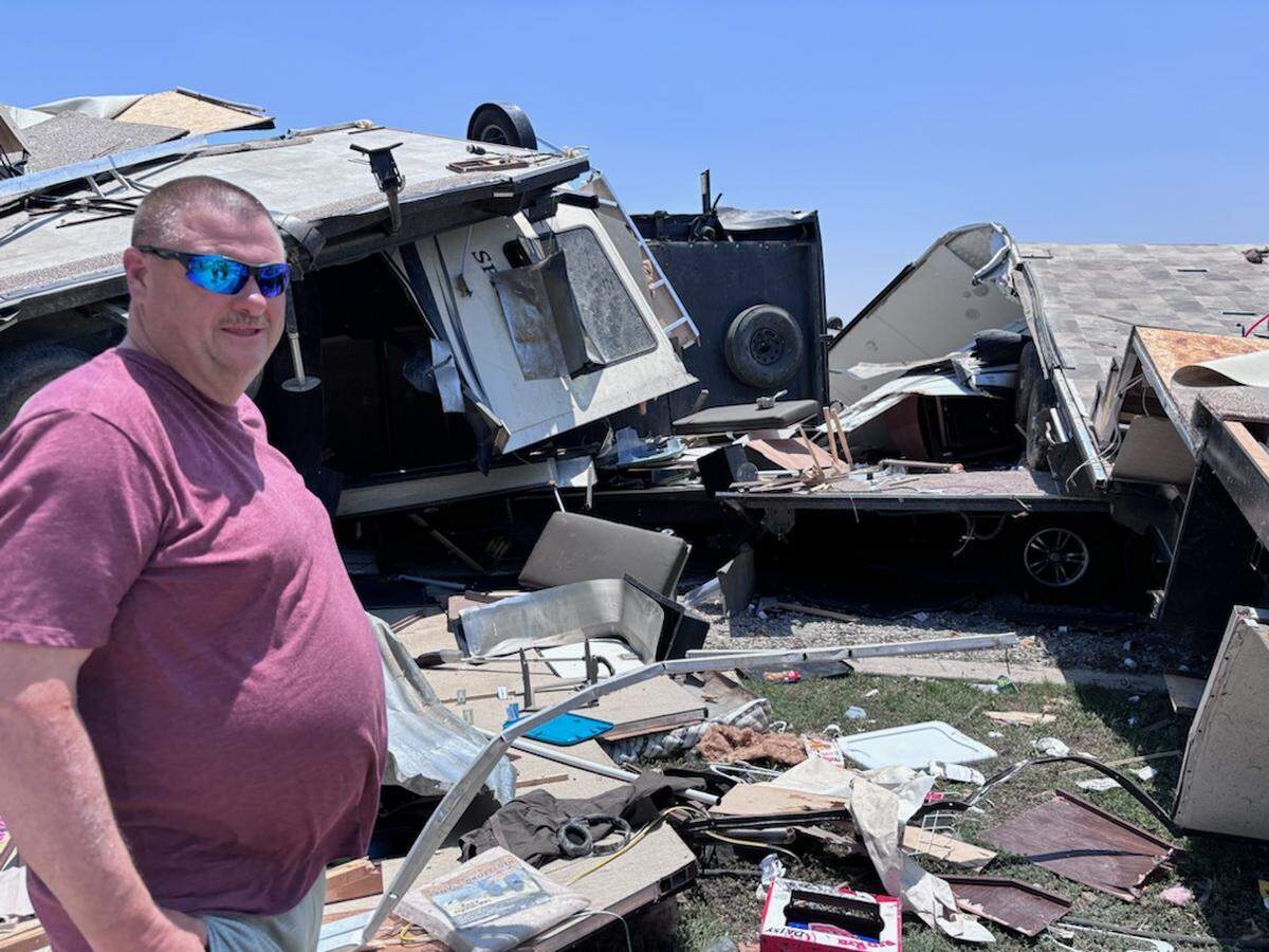 Bryan Looper, 57, of Sanger stands near wreckage at the Ray Roberts Marina RV park on Sunday, May 26, 2024. He said he pulled two people from the wreckage at the RV park at the Ray Roberts Marina. He said he had to move trees off the county road to reach the area.