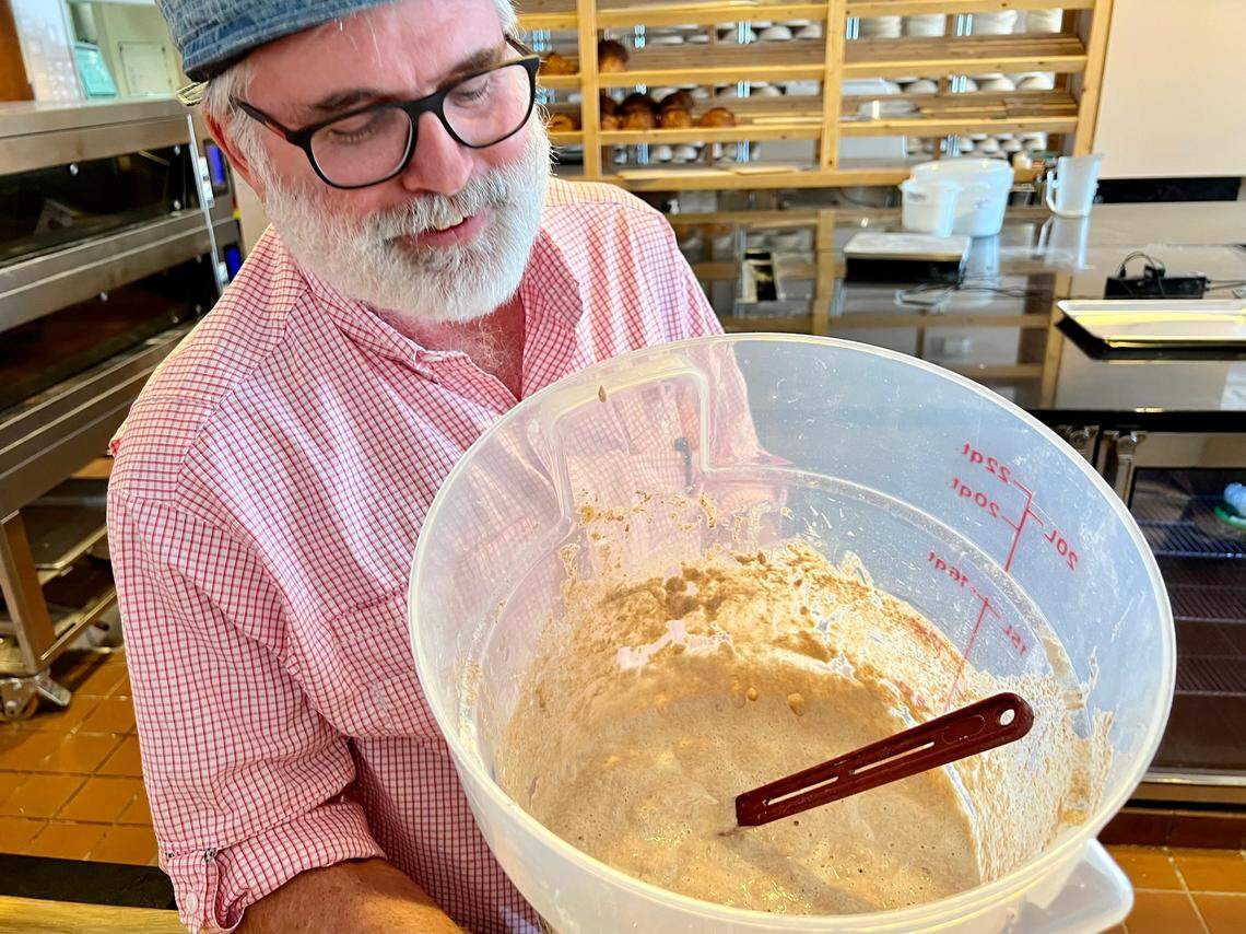 Baker Trent Shaskan proudly shows his sourdough starter at 3rd Street Market.